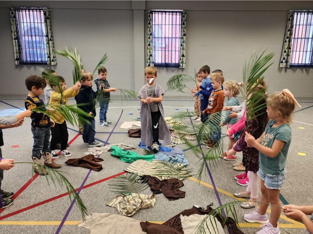 Children playing with palm at Coggin Kids Ministry