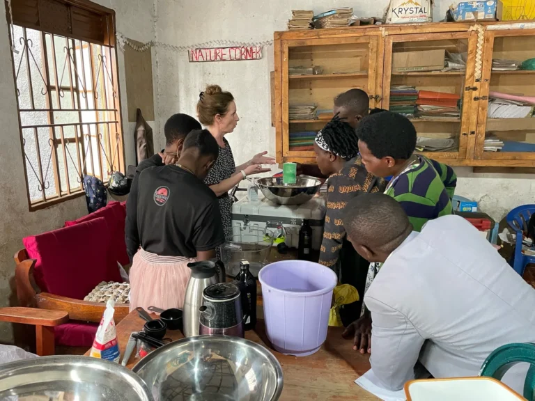 Woman from Coggin Church team teaching a hands-on session to local students in a classroom setting