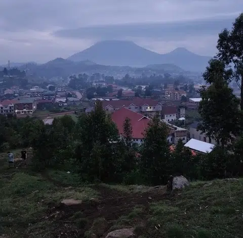 Scenic view overlooking a town with misty mountains in the background during a mission trip