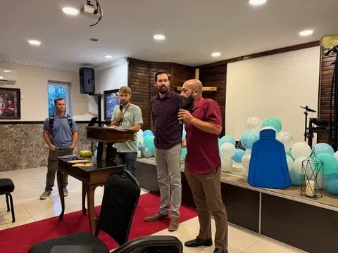 Worship leaders from Coggin Church speaking and leading in front of the congregation during a missions event