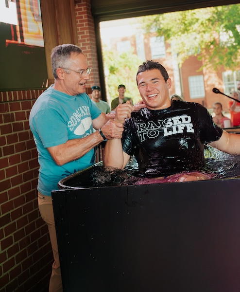 Student being baptized during a Coggin Youth gathering in Brownwood, TX